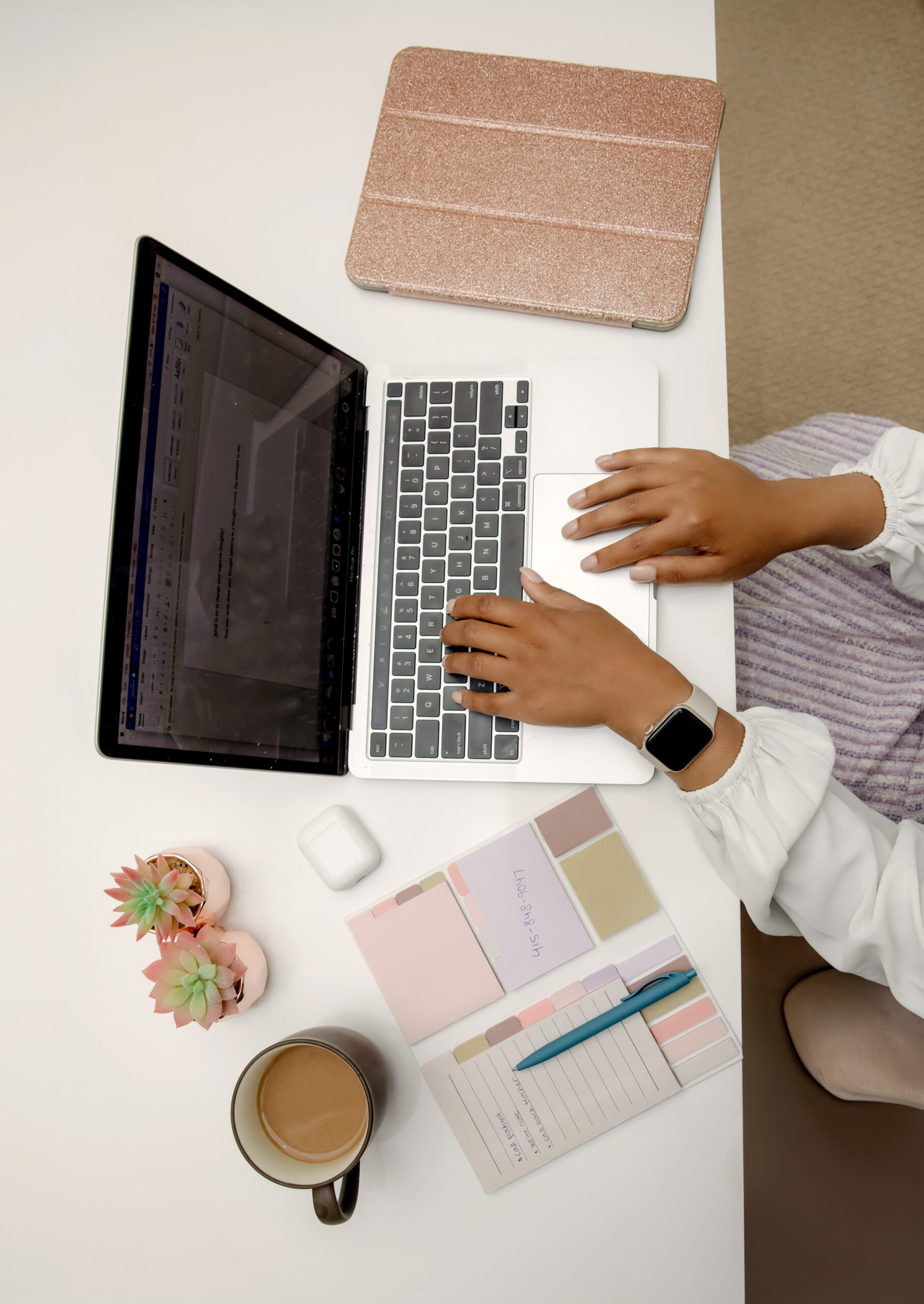 Person typing on a laptop while managing email and taking notes — illustrating strategies for managing email overwhelm with ADHD