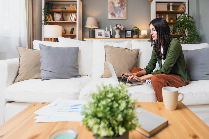 Person working from home on a couch with laptop, managing work-life boundaries
